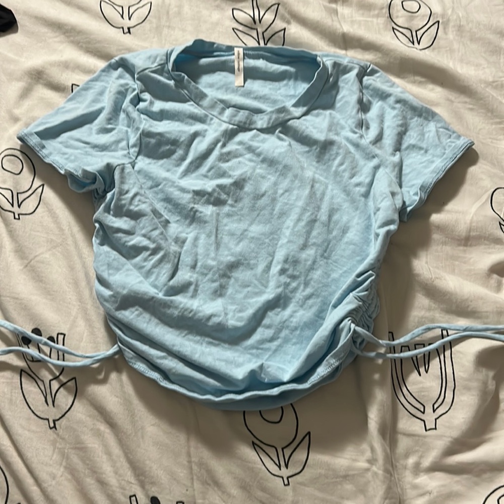 Light blue crop top with strings to tighten on the sides
